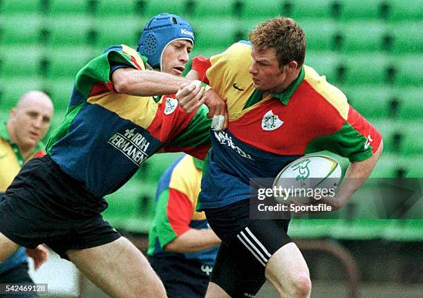 June 1999; Ireland's Malcolm O'Kelly is tackled by Paddy Johns. Ireland Rugby Squad Training, Stadium Australia, Sydney, Australia. Picture credit:...