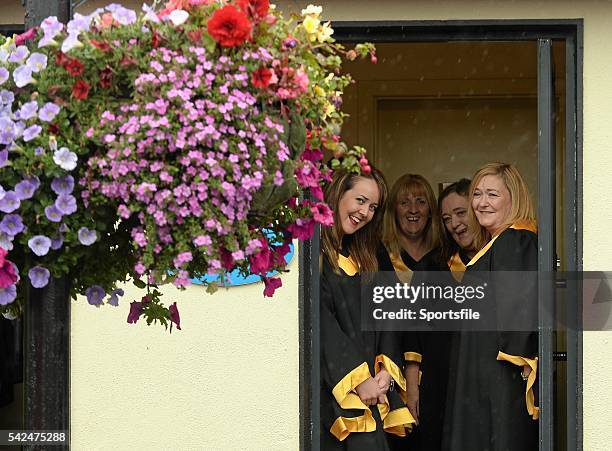 September 2015; Members of the Monasterevin Gospel Choir stay dry in a doorway during a rain shower. Irish Champions Weekend. The Curragh, Co....