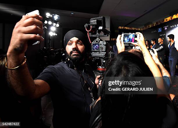 An Indian cameraman takes a selfie during the press conference for the 17th edition of IIFA Awards in Madrid on June 23, 2016. The IIFA Awards are...