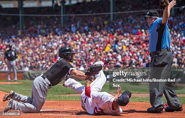 Adam Eaton of the Chicago White Sox is ruled safe at home by umpire Dana DeMuth after a past ball by Rick Porcello of the Boston Red So in the first...