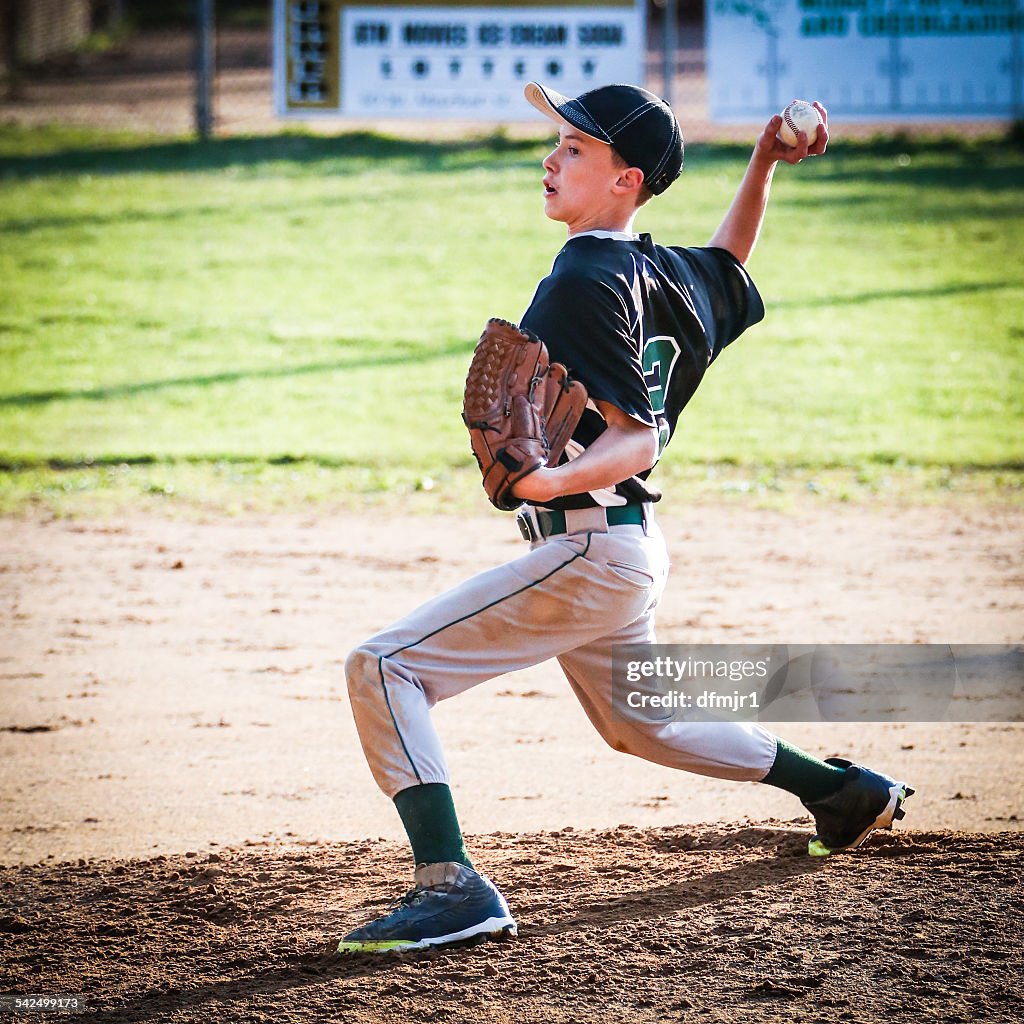 USA, Young boy (10-11) pitching on pitchers mound