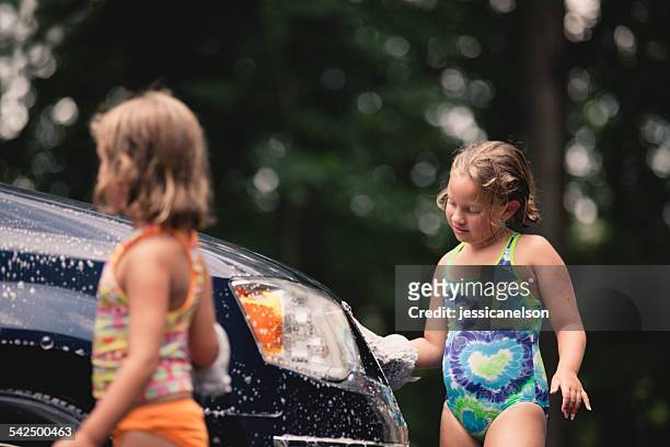 sisters (6-7, 8-9) washing van - girls taking a showering stockfoto's en -beelden