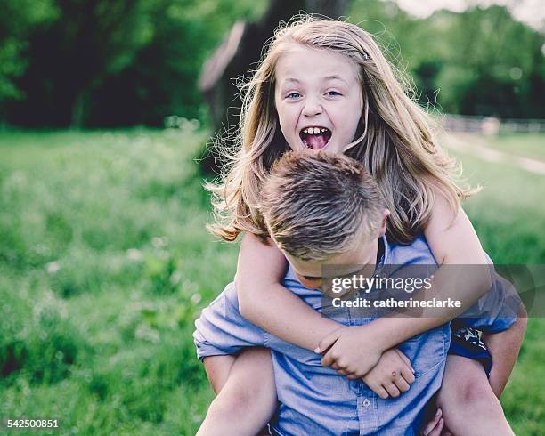 siblings (8-9, 10-11) enjoying themselves in countryside - girls playing with themselves bildbanksfoton och bilder