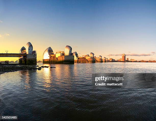 united kingdom, england, london, thames barrier towers at sunset - mattscutt stock pictures, royalty-free photos & images