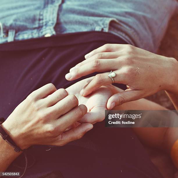 Close-up of woman touching a man's hand