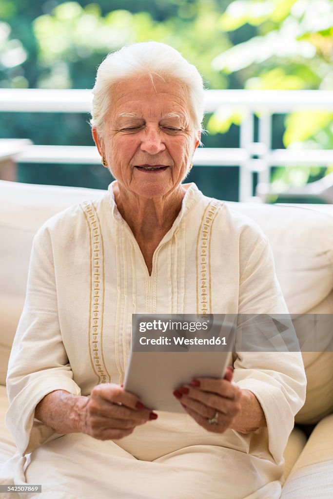 Portrait of senior woman using digital tablet