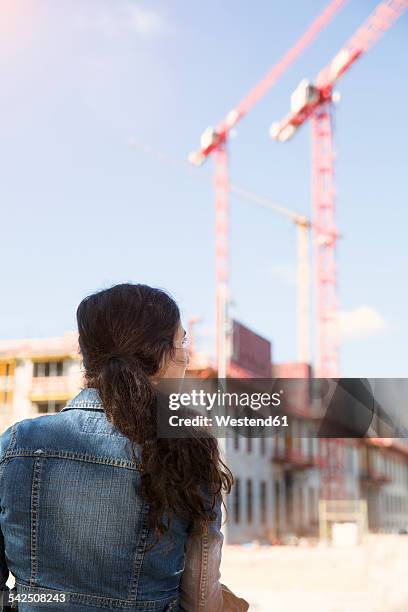 germany, berlin, young woman in front of construction site - ponytail hairstyle stock pictures, royalty-free photos & images