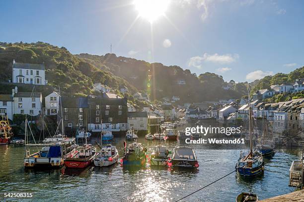 uk, cornwall, polperro, fishing boats in harbor in back light - fishing village 個照片及圖片檔