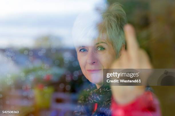 senior woman giving the finger - rejection hand stock pictures, royalty-free photos & images