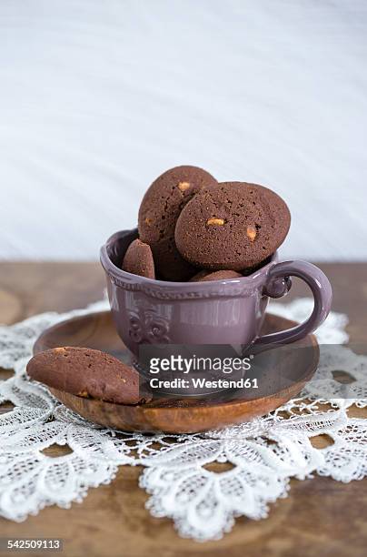 cup of chocolate cookies with chunks of white chocolate - doily stock pictures, royalty-free photos & images