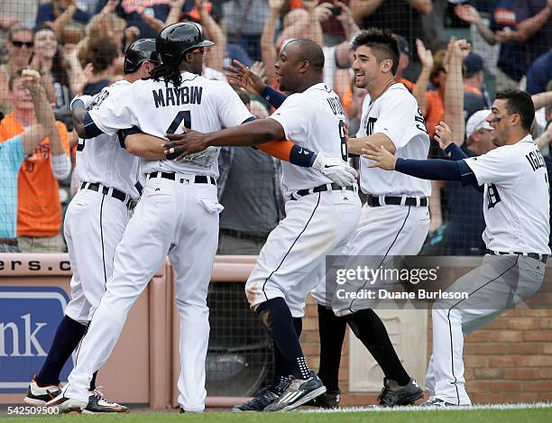 Cameron Maybin of the Detroit Tigers is surrounded by Ian Kinsler, Justin Upton, Nick Castellanos, and Jose Iglesias of the Detroit Tigers after...