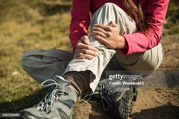 austria, tyrol, tannheimer tal, injured young woman on hiking tour - low section woman stock pictures, royalty-free photos & images