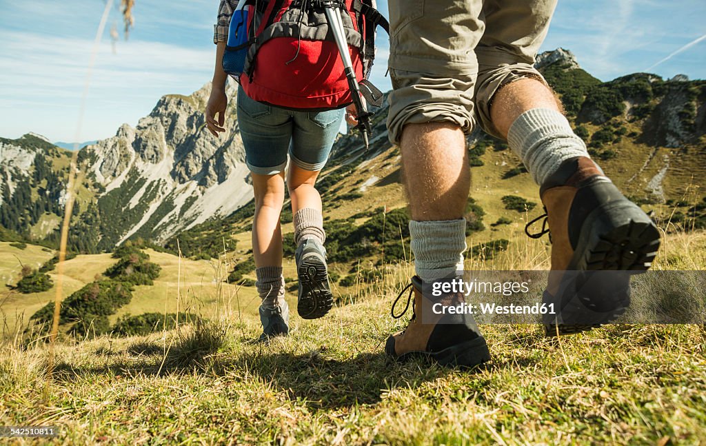 Austria, Tyrol, Tannheimer Tal, close-up of young couple hiking