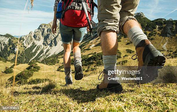austria, tyrol, tannheimer tal, close-up of young couple hiking - hiking boot stock pictures, royalty-free photos & images