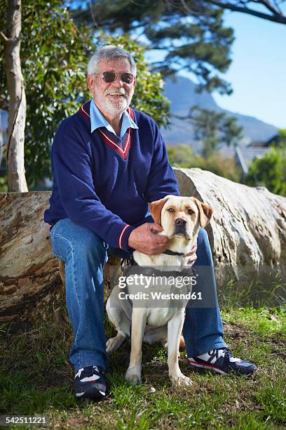 portrait of visually impaired man and his guide dog - visual impairment stock-fotos und bilder