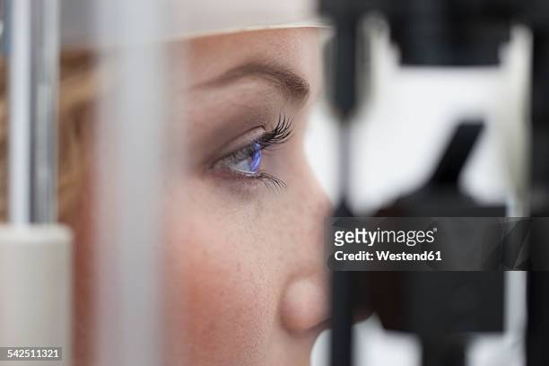 woman receiving eye test - eye test equipment stock pictures, royalty-free photos & images