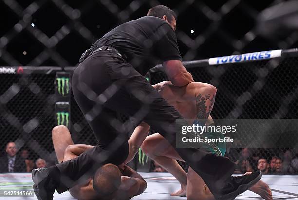 December 2015; Referee John McCarthy pulls Conor McGregor off Jose Aldo to finish their featherweight title bout. UFC 194: Jose Aldo v Conor...