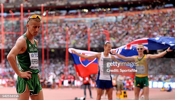 August 2015; Rob Heffernan of Ireland after finishing 5th in the final of the Men's 50km Race Walk while gold medal winner Matej Toth of Slovakia and...