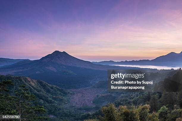 sunrise at kintamani(from left - mt. batu, mt. aba - bali volcano stock pictures, royalty-free photos & images