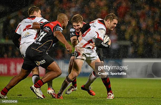 November 2014; Darren Cave, Ulster, is tackled by Matthew Pewtner, Newport Gwent Dragons, as Aled Brew moves in. Guinness PRO12, Round 7, Ulster v...