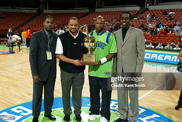Jeff Myers of the Greenville Groove receives his Defensive Player of the Year Award at the game against the Columbus Riverdragons. Also pictured are...