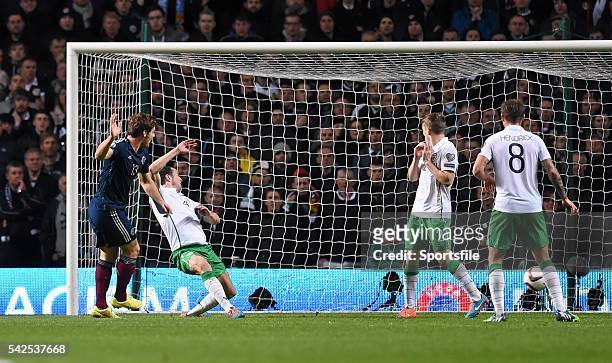 November 2014; Chris Martin, Scotland, shoots at goal despite the attempts of John O'Shea, Republic of Ireland. UEFA EURO 2016 Championship...
