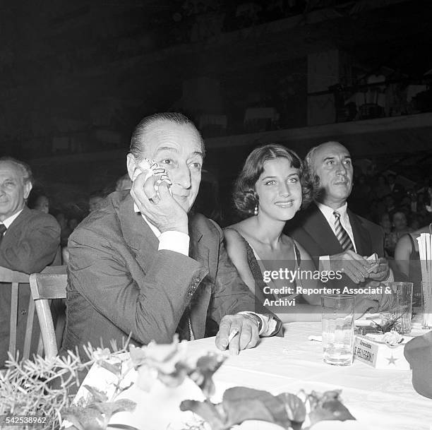 Italian actor Totò and his wife Italian actress Franca Faldini, sitting at a dinner table during a party. Rome, 1955