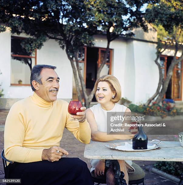 Mexican-born American actor Anthony Quinn drinking in his garden with his wife Jolanda Addolori. 1970s