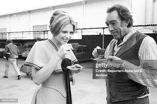 Mexican-born American actor Anthony Quinn and American actress Pamela Tiffin drinking coffee during a break on the set of Los amigos. 1973