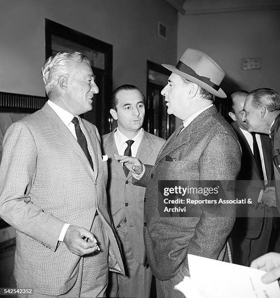 Italian actor and director Vittorio De Sica talking to Italian director Roberto Rossellini at a congress. 1961