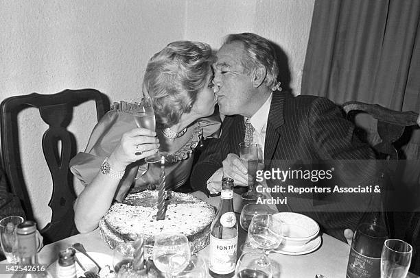 Mexican-born American actor Anthony Quinn kissing his wife Jolanda Addolori during a party. 1982