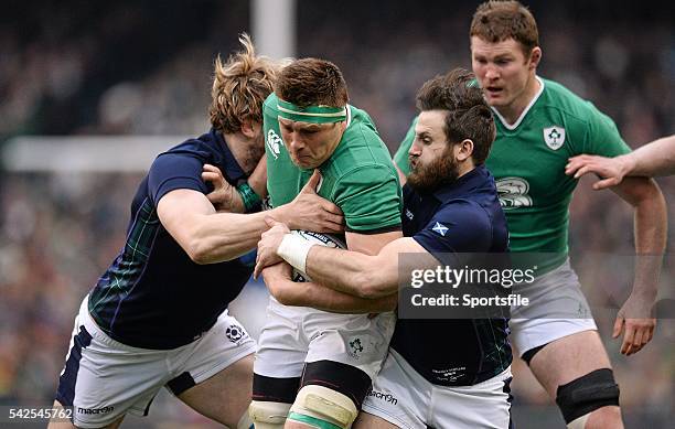 March 2016; CJ Stander, Ireland, is tackled by Richie Gray, left, and Tim Visser, Scotland. RBS Six Nations Rugby Championship, Ireland v Scotland,...