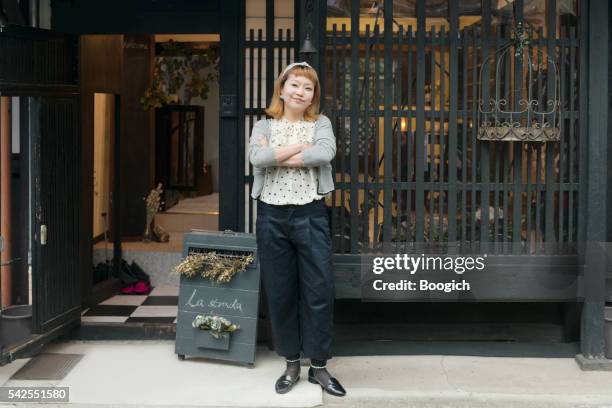 proud japanese small business owner standing outside her kyoto store - woman full frame stock pictures, royalty-free photos & images