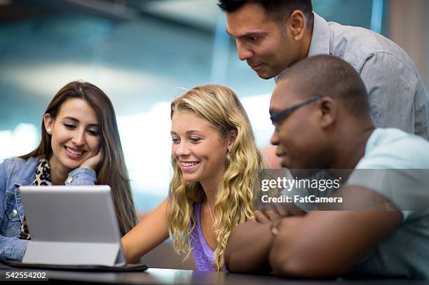 watching a video on a digital tablet - digital camera for teenager stock pictures, royalty-free photos & images