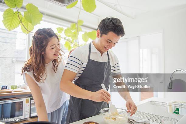 japanese young couple cooking on holiday - the japanese wife stock pictures, royalty-free photos & images