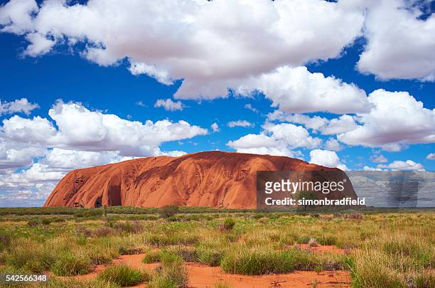 clouds over uluru - uluru rock stock pictures, royalty-free photos & images