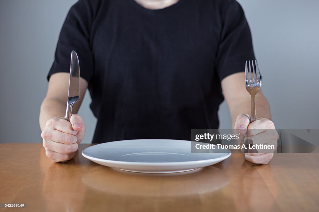 Man sitting at a table waiting for food