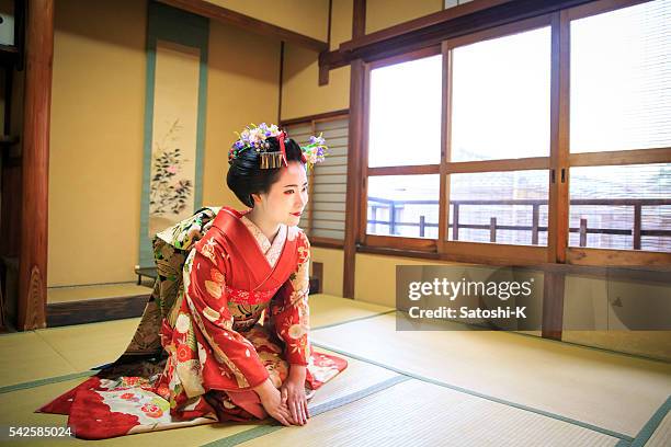maiko girl sitting in tatami room for greetings - geisha in training stock pictures, royalty-free photos & images