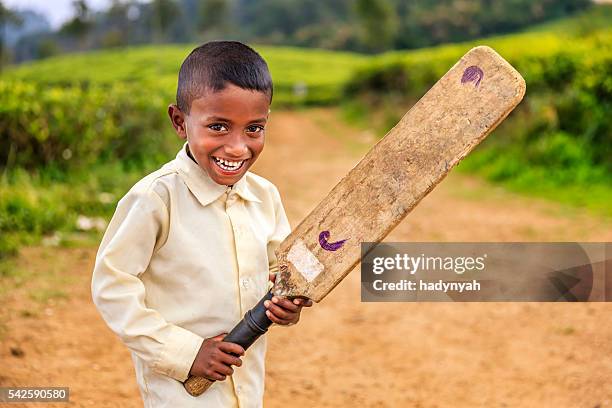 sri lankan little boy playing cricket on tea plantation - cricket player stock pictures, royalty-free photos & images