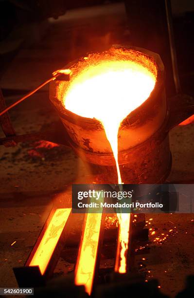 Battaglia artistic foundry, in Milan. This is the foundry where the works by Italian sculptor Arnaldo Pomodoro are made. Melted bronze casting....