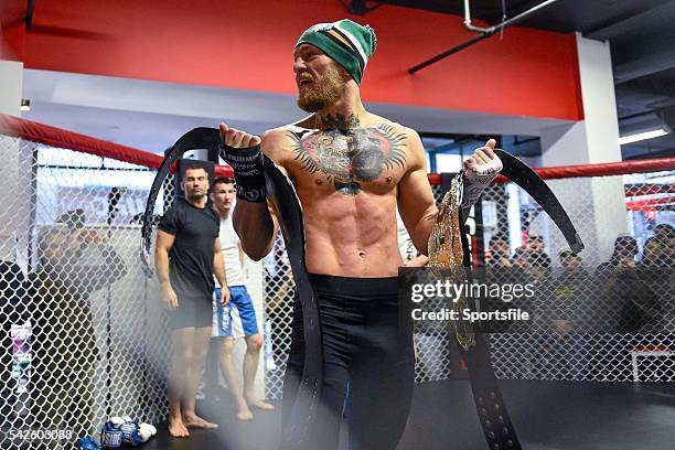 January 2015; Conor McGregor holds two UFC title belts during an open workout session ahead of his fight against Dennis Siver in TD Garden, Boston,...