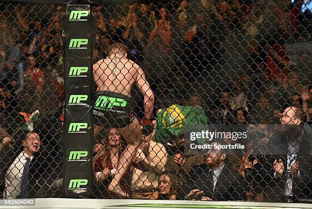 January 2015; Conor McGregor climbs into the crowd to greet UFC Featherweight Champion Jose Aldo after defeating Dennis Siver. UFC Fight Night, Conor...