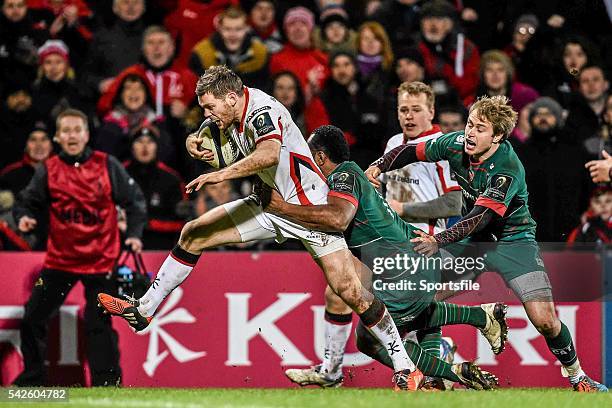 January 2015; Darren Cave, Ulster, on his way to scoring his third try of the game despite the tackle of Vereniki Gonevar, Leicester Tigers. European...