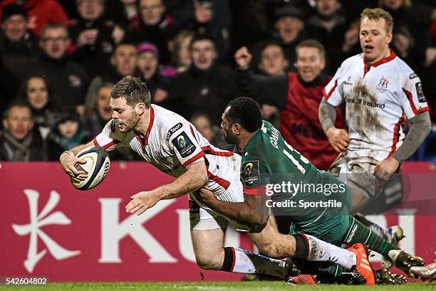 January 2015; Darren Cave, Ulster, dives over to score his third try of the game despite the tackle of Vereniki Gonevar, Leicester Tigers. European...