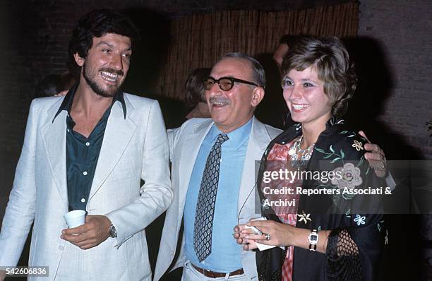 Italian actor Gigi Proietti, Italian director Alberto Lattuada and Italian actress Lina Polito loughing together. Taormina, August 1974