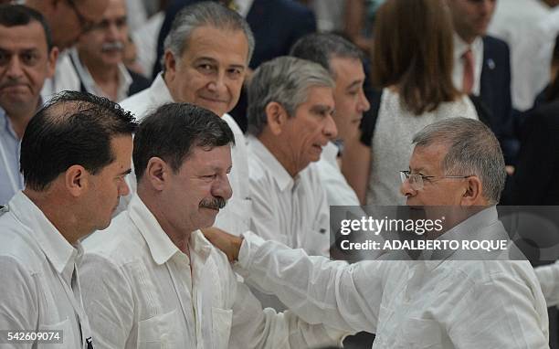 Colombian retired General Javier Flores greets FARC-EP Commander Rodrigo Granda during the ceasefire ceremony between the Colombian government and...