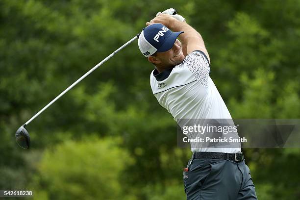 Luke Guthrie plays a shot from the 11th tee during the first round of the Quicken Loans National at Congressional Country Club on June 23, 2016 in...