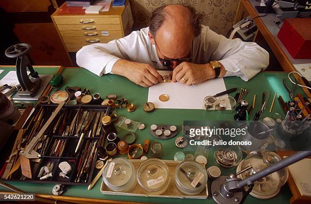 Watchmaker uses precise instruments and magnifying glasses to work on a watch for Patek Philippe in Geneva. Patek Philippe is one of many prominent...