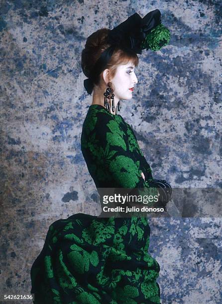 Model wears a Christian Lacroix dress from his 1987 spring-summer haute couture line for Patou. The 19th century-style dress is emerald green and...