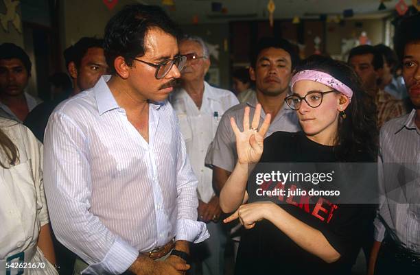 Deaf actress Marlee Matlin uses sign language to speak to Nicaraguan President Daniel Ortega and others on the set of the 1987 film Walker. Filmed on...